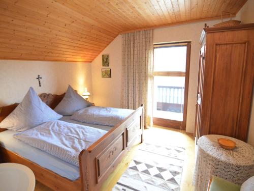 a bedroom with a bed with a cross on it at Ferienhaus in Saldenburg mit Sauna in Saldenburg