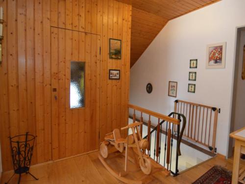 a room with a wooden wall and a staircase at Ferienhaus in Saldenburg mit Sauna in Saldenburg