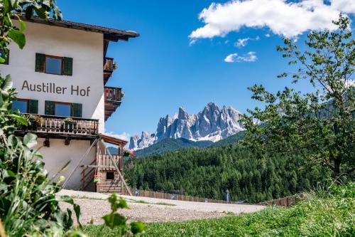 a hotel with a view of the mountains at Austillerhof - Urlaub auf dem Bauernhof in Funes