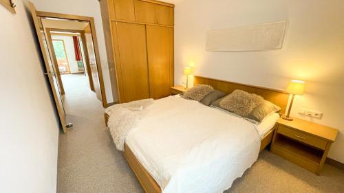 a bedroom with a large white bed with two pillows at Ferienwohnung Königsleiten 77 - Top 9 in Königsleiten
