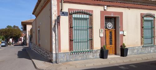 a building with a clock on the side of a street at Casa SayLavy in El Descargador