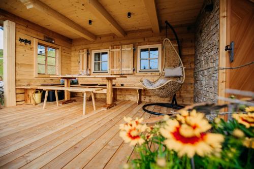 a wooden room with a table and a chair at Chalet Vierlauchen in Bramberg am Wildkogel