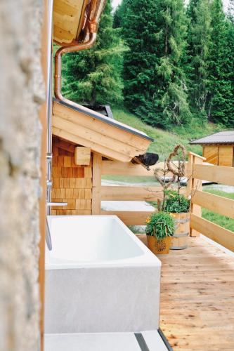a white sink sitting on a deck in a house at Chalet Vierlauchen in Bramberg am Wildkogel