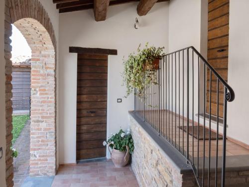 an entrance to a house with a staircase and a door at Authentic Marche Hideaway in SantʼAngelo in Vado