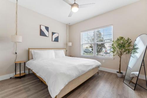 a bedroom with a large bed and a window at Pinnacle Apartments W Amenties by Heavenly Homes in Orlando