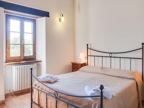 a bedroom with a bed and a window at Authentic Marche Hideaway in SantʼAngelo in Vado