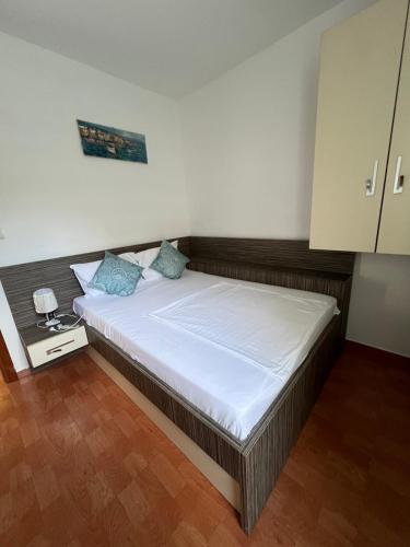 a bedroom with a large bed with blue pillows at Maya bay in Kotor