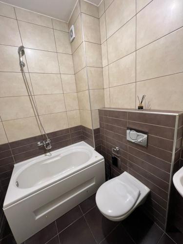 a bathroom with a tub and a toilet and a sink at Maya bay in Kotor