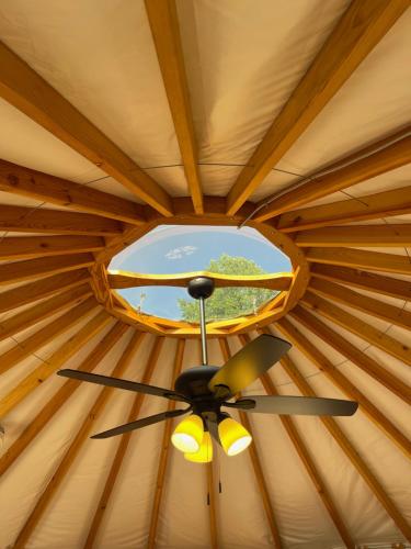 a ceiling of a yurt with a window at Mountain Aire Cottages, Inn, & Glamping in Clayton