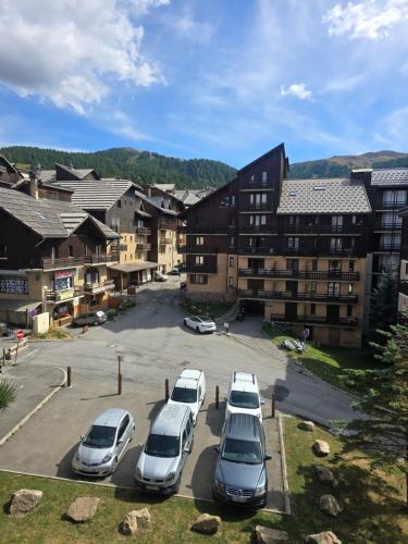 a group of cars parked in a parking lot at Appartement chaleureux in Risoul