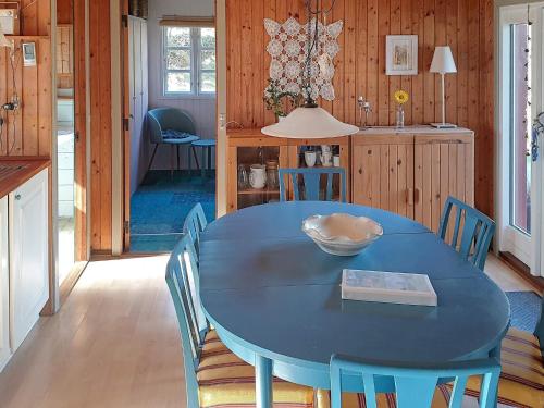 a dining room with a blue table and chairs at Secluded Retreat by Limfjorden - By Traum Ferienwohnungen in Sindrup