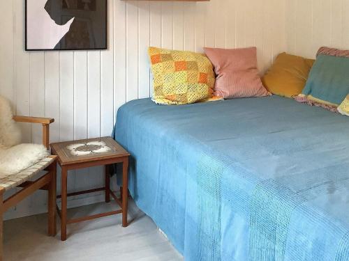 a bed in a room with a table and a chair at Secluded Retreat by Limfjorden - By Traum Ferienwohnungen in Sindrup