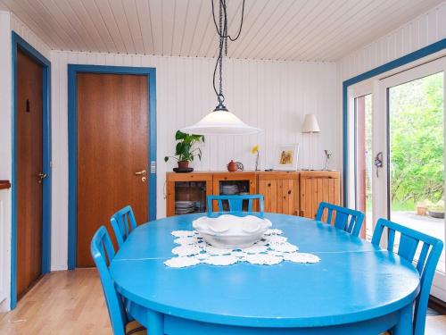 a dining room with a blue table and chairs at Secluded Retreat by Limfjorden - By Traum Ferienwohnungen in Sindrup