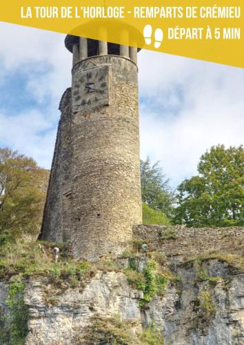 a stone tower with a sign on top of it at La Maison de l'Apothicaire - Un refuge enchanté avec balnéo en hyper-centre in Crémieu