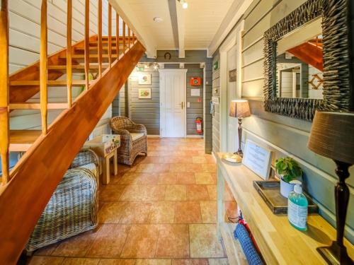 a hallway with a staircase in a tiny house at Chic chalet with wellness in Barvaux