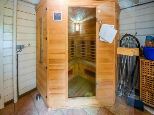 a sauna with a glass door in a wooden building at Chic chalet with wellness in Barvaux