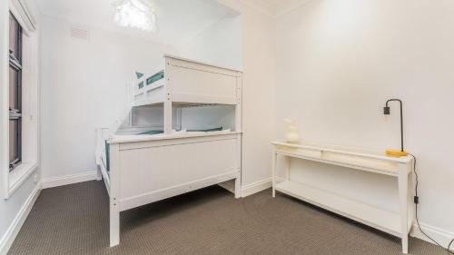 a white refrigerator in a room with a table at Carlton Place in Cowes