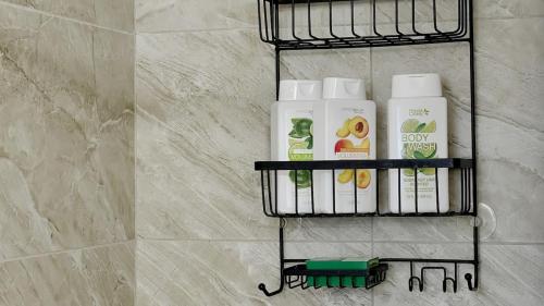 a rack with toiletries on a wall in a bathroom at Private home in West Palm in West Palm Beach