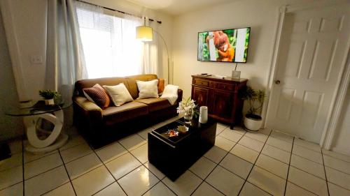a living room with a couch and a table at Private home in West Palm in West Palm Beach