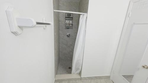 a bathroom with a shower with a shower curtain at Private home in West Palm in West Palm Beach