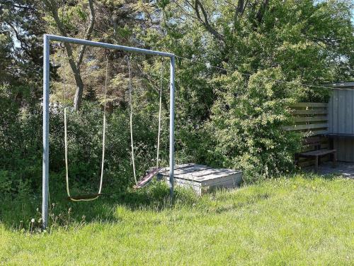 a swing in the grass in a yard at 6 person holiday home in Vesløs-By Traum in Øsløs