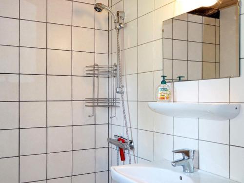 a bathroom with a shower with a sink and a mirror at 6 person holiday home in Vesløs-By Traum in Øsløs
