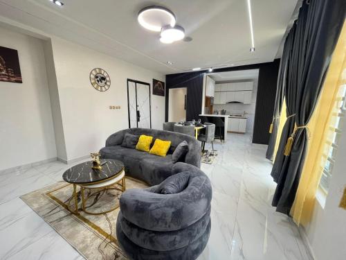 a living room with a couch and a table at CASONEViIIE apartments lekki in Lagos