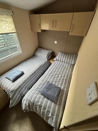 Ένα ή περισσότερα κρεβάτια σε δωμάτιο στο The Lake District Caravan