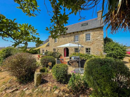 an old stone house with a red door at Ty Levenez in Paimpol