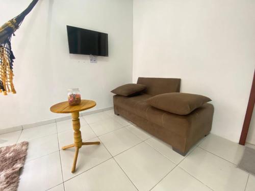 a living room with a couch and a table at Recanto Buriti in Barreirinhas