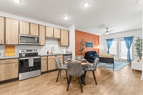 a kitchen and living room with a table and chairs at Adeline Apartments 15m to Parks, Pet Friendly, Free Parking by Heavenly Homes in Orlando