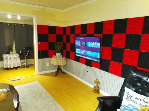 a living room with a tv on a wall at Home Away from Home - Guest Suite 1 in Red Deer