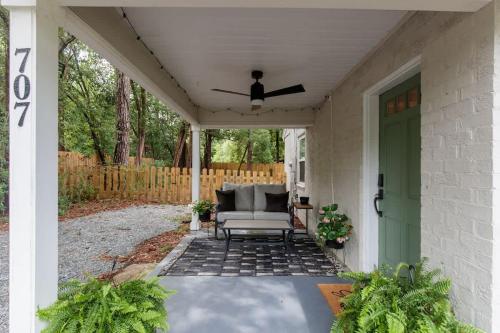 a porch with a couch and a green door at Restful Retreat with 4 Beds Sleeps 6 in Valdosta