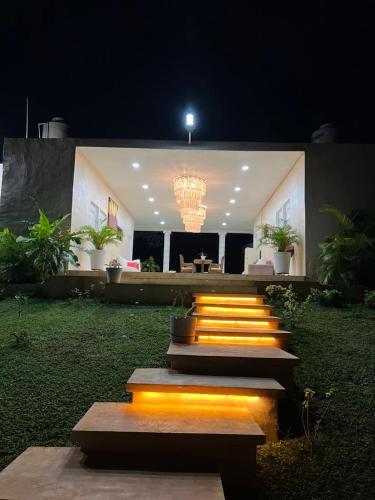 a group of stairs with lights on them at night at Quinta YaaxBe in Homún