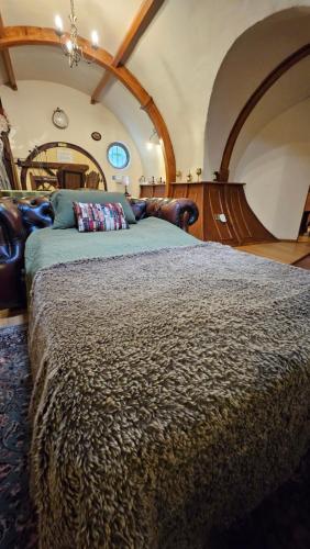a bedroom with a large bed in a room at West Stow Pods in Bury St Edmunds in West Stow