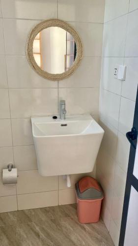 a bathroom with a white sink and a mirror at Villa Katerina Kendwa in Kendwa