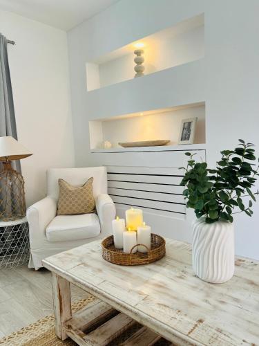 a living room with a table with candles and a chair at Southkey House in Repton