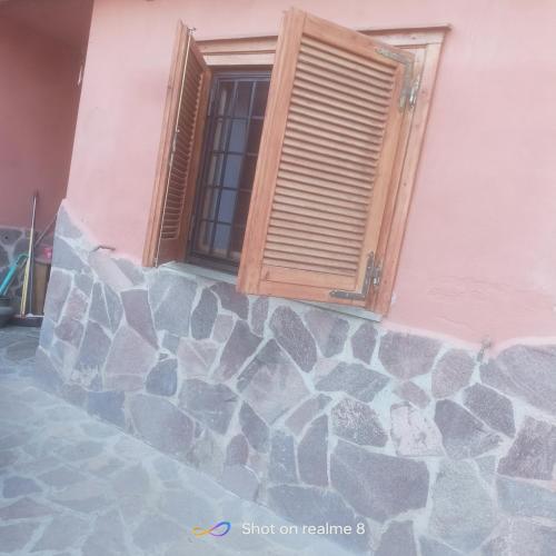 a building with a window and a stone wall at La Dimora Di Ale in Monterosi