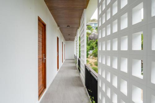 a hallway of a house with white walls and a wooden ceiling at The Pinnacle Katanoi in Kata Beach