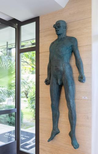 a statue of a man on the side of a building at Hotel Acapulco in Forte dei Marmi