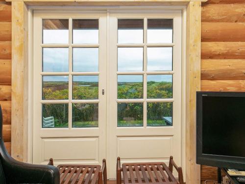 a room with a door with windows and a tv at 10 person holiday home in Frøstrup-By Traum in Frøstrup