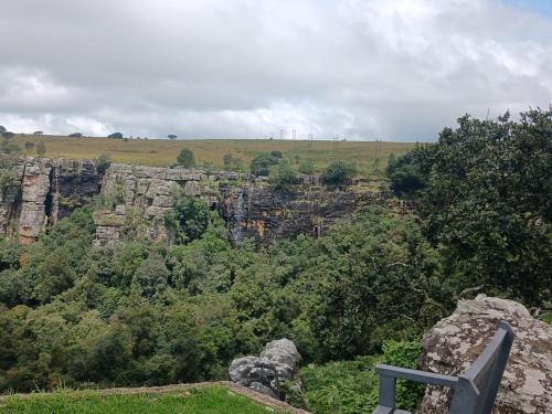 a view of a mountain with trees and rocks at Panorama home 19 in Graskop