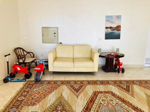 a living room with a couch and a table at Lovely garden small apartment in Novi Sad