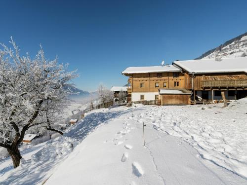 a snow covered building on top of a snow covered hill at Apartment Uttendorf near Ski Slopes in Uttendorf