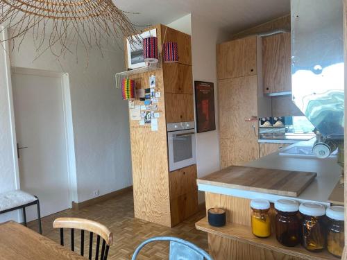 a kitchen with a counter with jars of honey at Dunes & Vagues, appartement avec balcon vue mer in Fort-Mahon-Plage