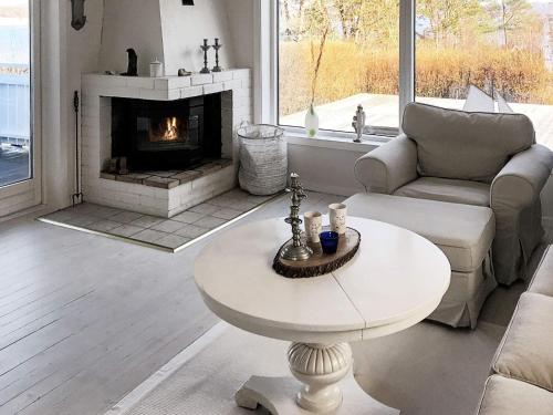 a living room with a table and a fireplace at 6 person holiday home in Åskloster-By Traum in Åskloster
