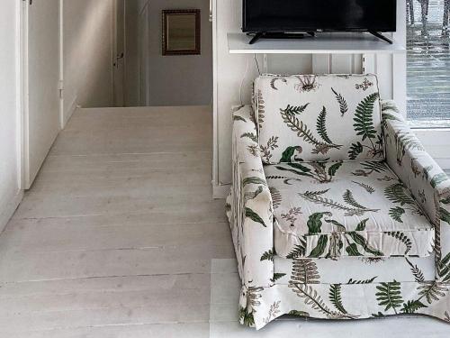 a living room with a chair and a television at 6 person holiday home in Åskloster-By Traum in Åskloster