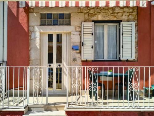 a white fence in front of a building with windows at Home AGM in Pozzallo