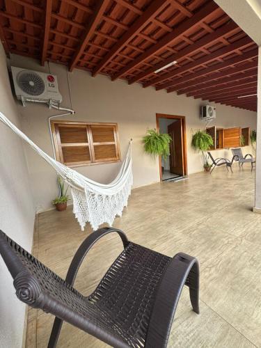 a hammock in a room with a patio at Casa Canto do Araguaia in Barra do Garças