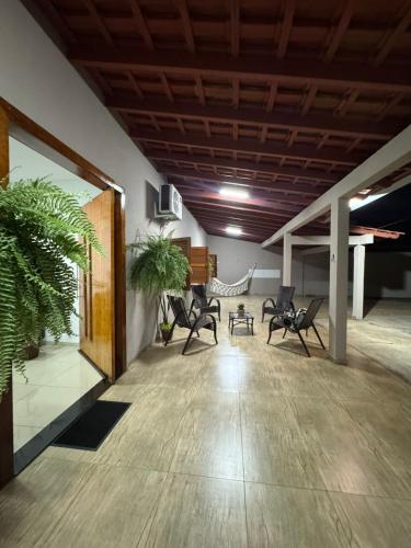 a room with chairs and a hammock in it at Casa Canto do Araguaia in Barra do Garças